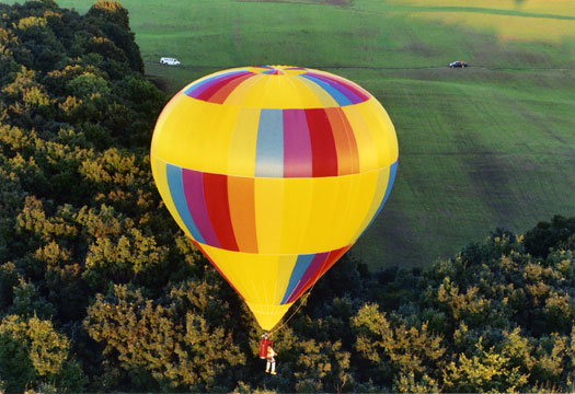 Both balloons from nearby roads, positioning vehicles in the open field for recovery.